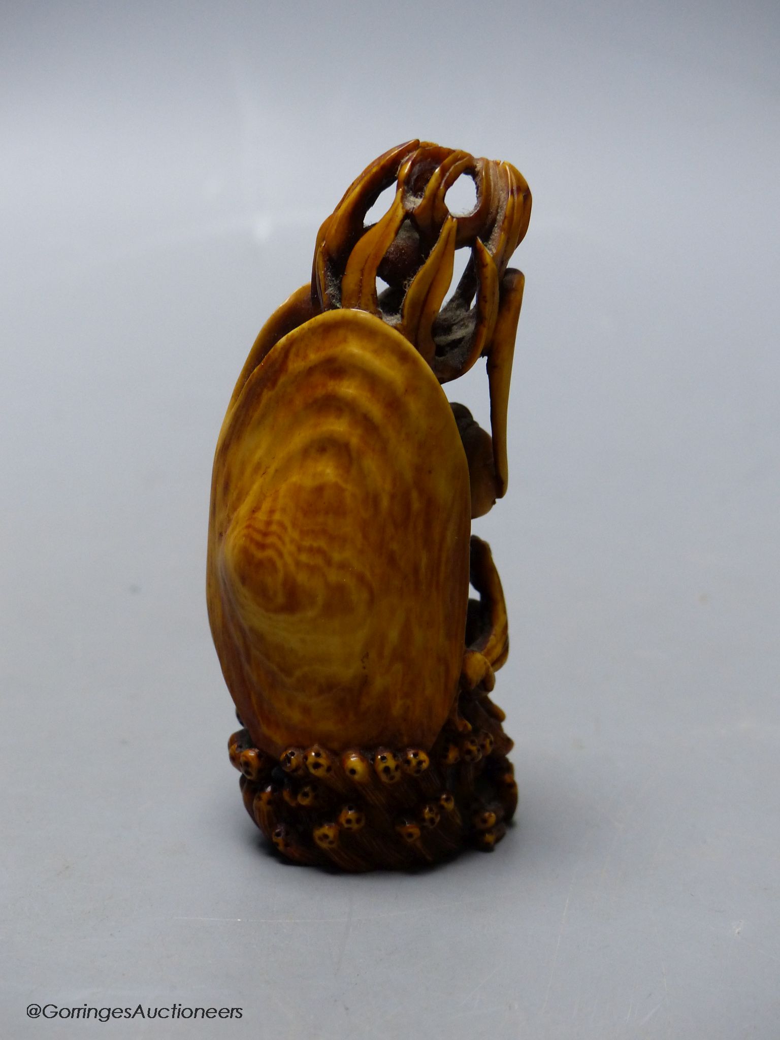 A Chinese ivory figure of a woman in a clam shell, 19th century